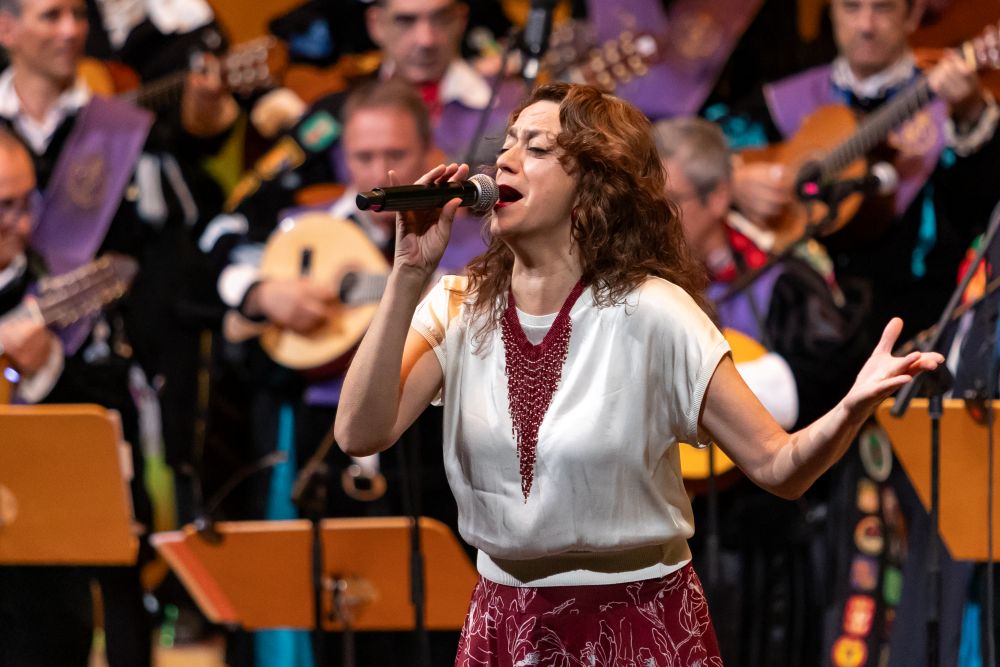 Carmen París interpreta una canción durante la gala solidaria Voces que Importan acompañada por la Tuna de Ingenieros de Zaragoza.